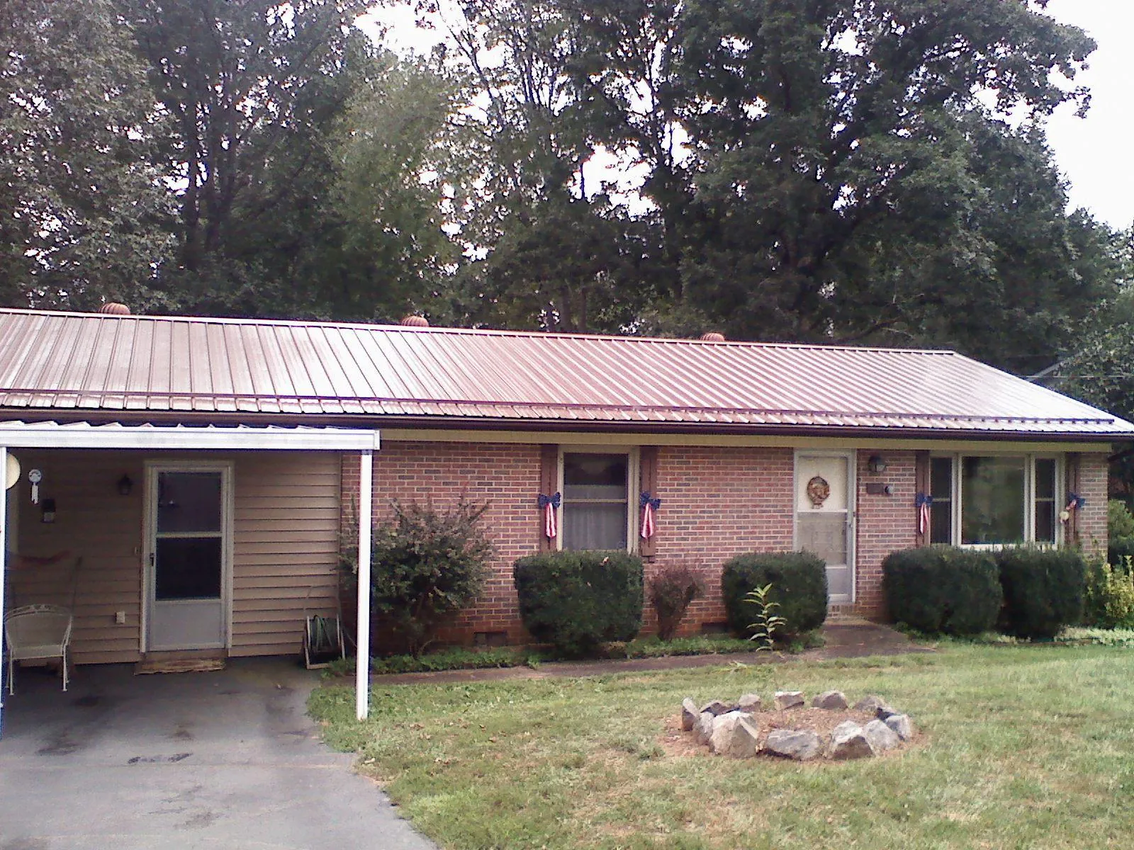 Bronze metal roof and carport on a brick ranch home — Roof Repair work by our crew in Pleasant Shade